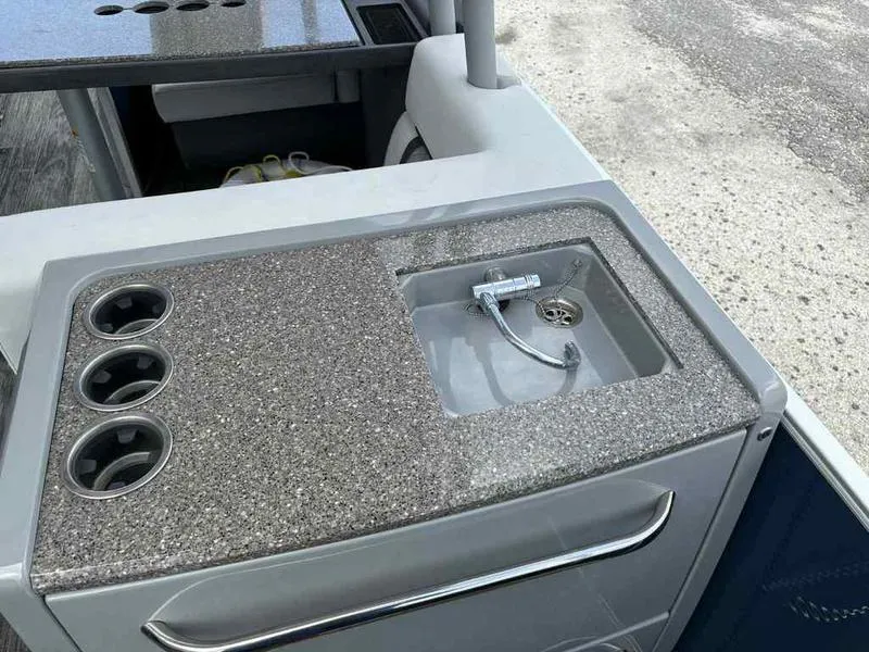 Slide: The Image of 2023 Godfrey AquaPatio 255 SDC boat sink and cup holders on deck. - 15