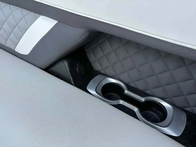 Slide: The Image of 2023 Godfrey AquaPatio 255 SDC interior with quilted upholstery and dual cup holders. - 18