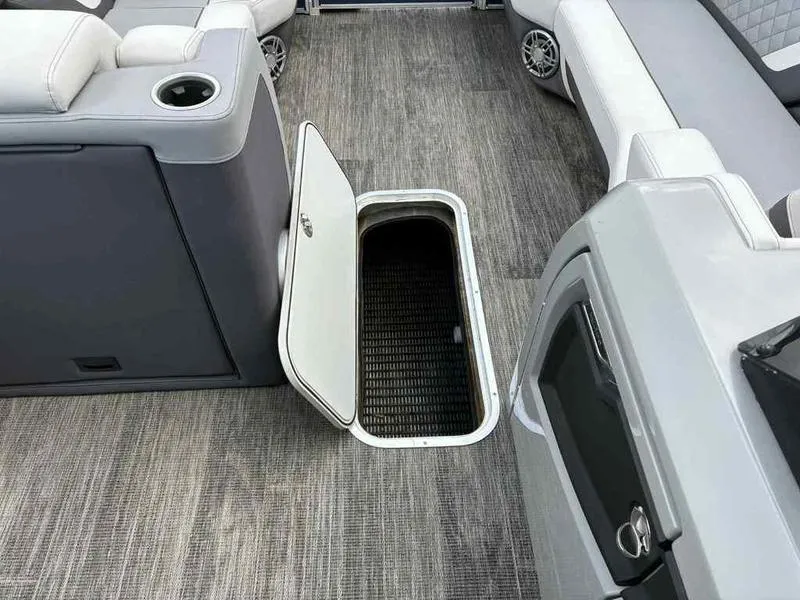 Slide: The Image of 2023 Godfrey AquaPatio 255 SDC interior with open storage compartment and seating. - 21