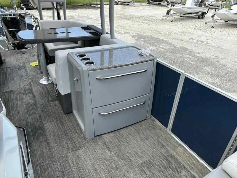 Slide: The Image of 2023 Godfrey AquaPatio 255 SDC interior with seating and storage on a pontoon boat. - 23