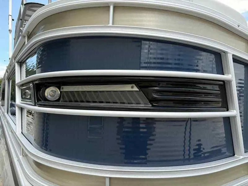 Slide: The Image of Close-up of 2023 Godfrey AquaPatio 255 SDC pontoon boat's sleek exterior design. - 3