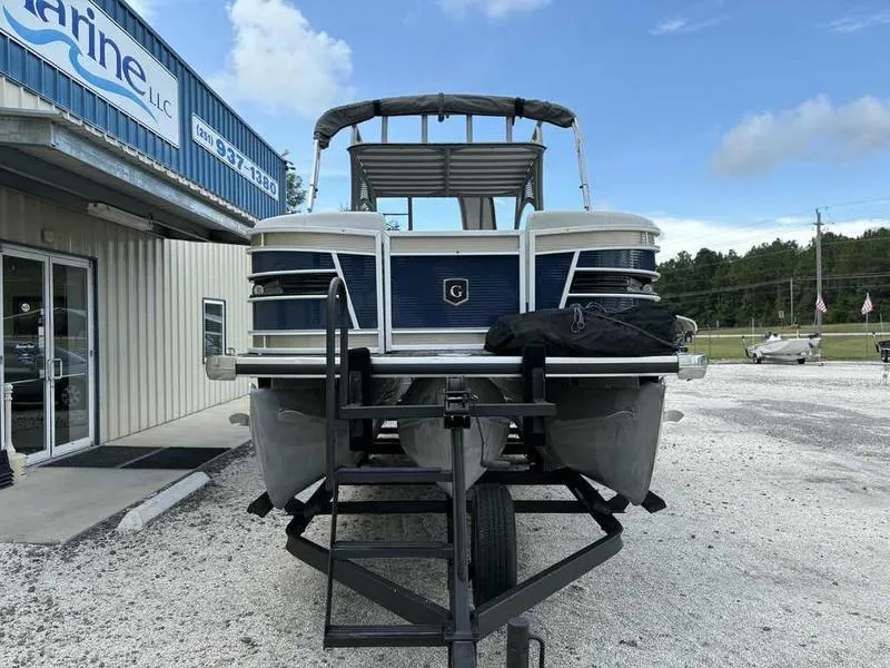 Slide: The Image of 2023 Godfrey AquaPatio 255 SDC pontoon boat on trailer, parked outside dealership. - 30