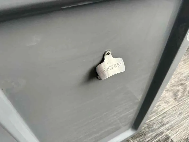 Slide: The Image of Close-up of a 2023 Godfrey AquaPatio 255 SDC boat detail with logo. - 31