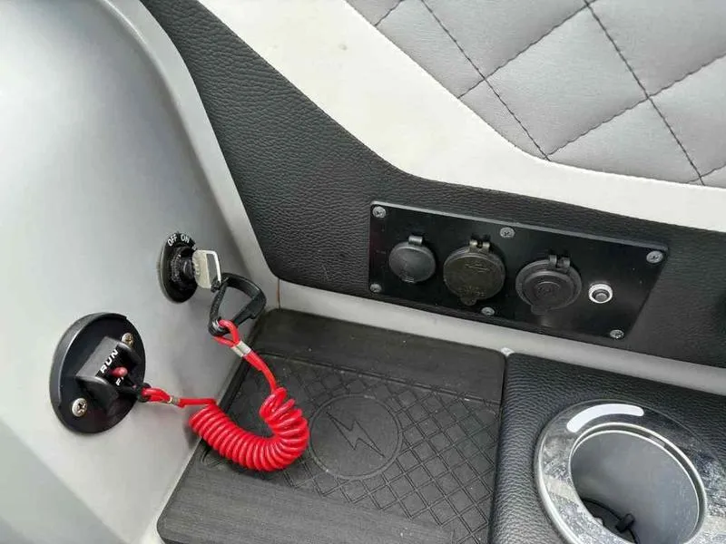 Slide: The Image of Control panel of 2023 Godfrey AquaPatio 255 SDC with switches and cup holder. - 32