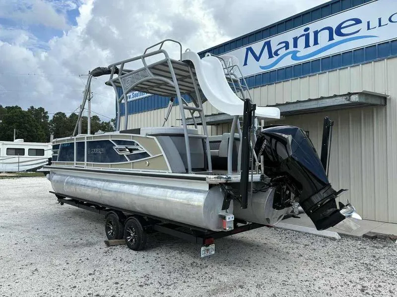 Slide: The Image of 2023 Godfrey AquaPatio 255 SDC pontoon boat with slide, parked outside marine dealership. - 33