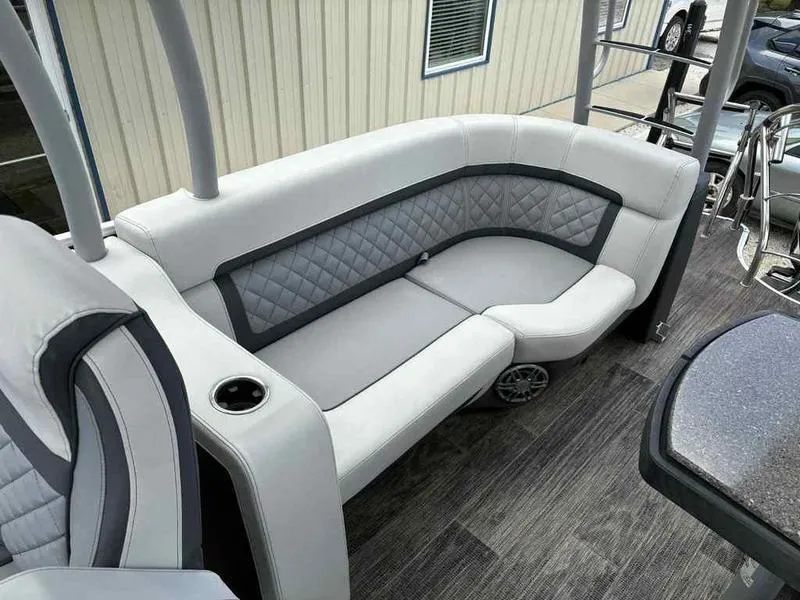 Slide: The Image of Luxurious seating on 2023 Godfrey AquaPatio 255 SDC pontoon boat, featuring elegant upholstery. - 7