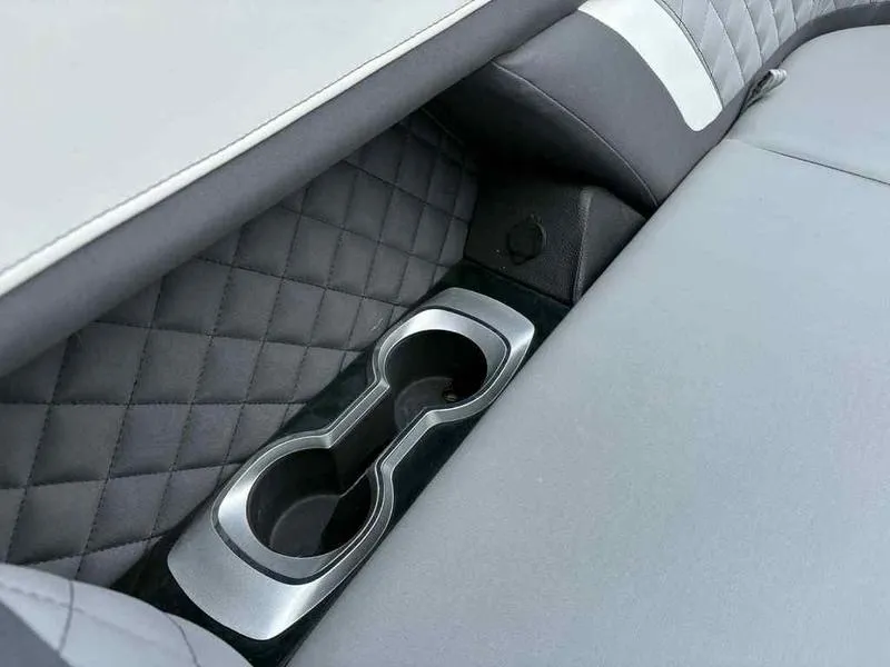 Slide: The Image of 2023 Godfrey AquaPatio 255 SDC interior with quilted upholstery and dual cup holders. - 9