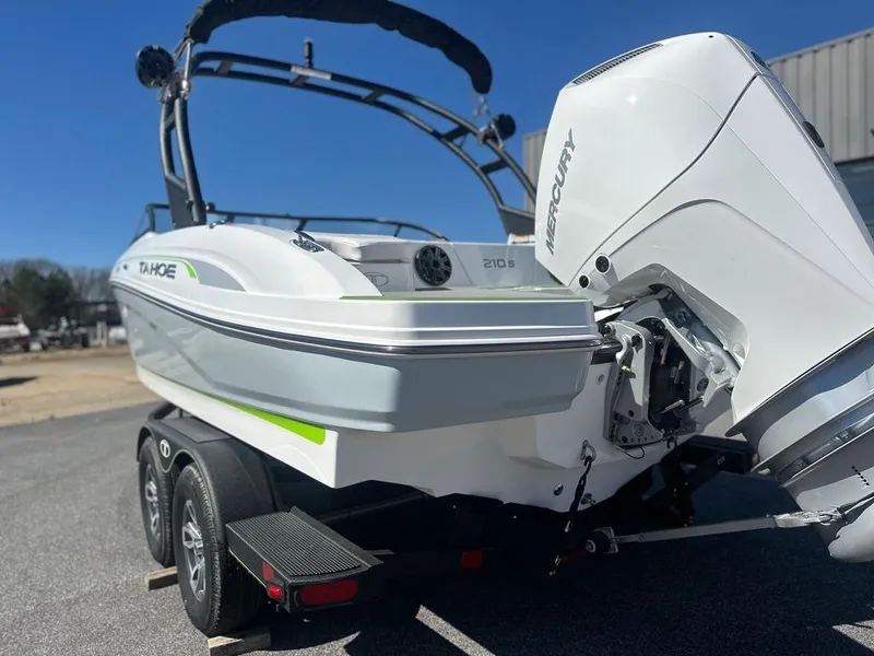 Slide: The Image of 2024 Tahoe 210 S boat with Mercury outboard engine on trailer. - 11