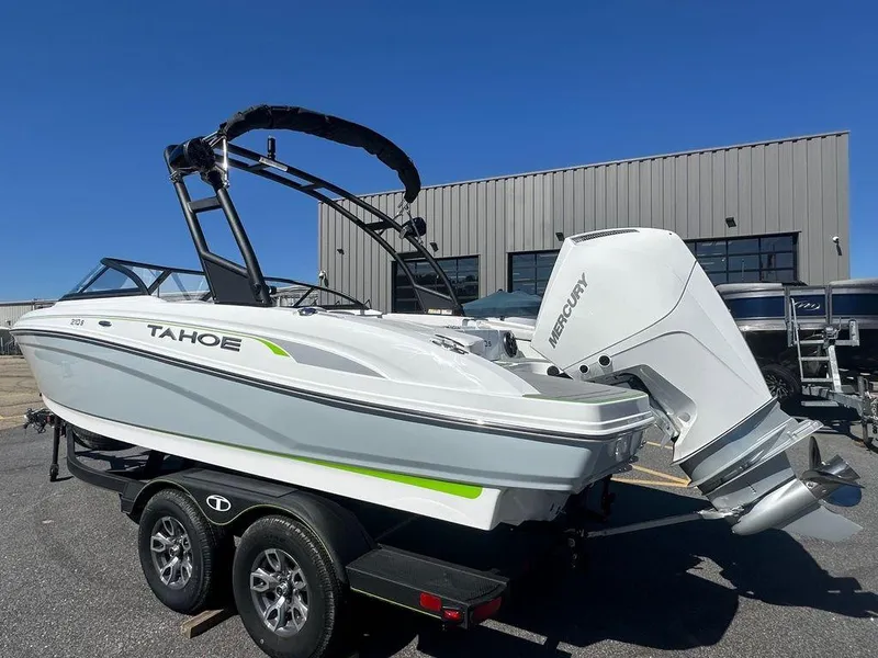 Slide: The Image of 2024 Tahoe 210 S boat with Mercury outboard engine on trailer. - 12