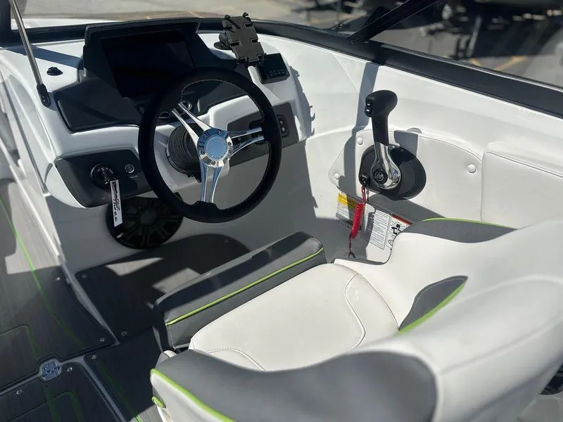 Slide: The Image of 2024 Tahoe 210 S boat cockpit with steering wheel and control panel. - 7