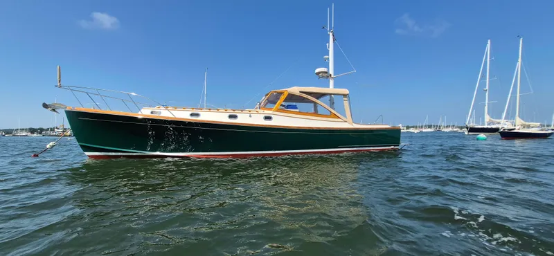 The Image of 1997 Able 44 Downeast Express Cruiser on calm water, clear sky, other boats in background. - 0