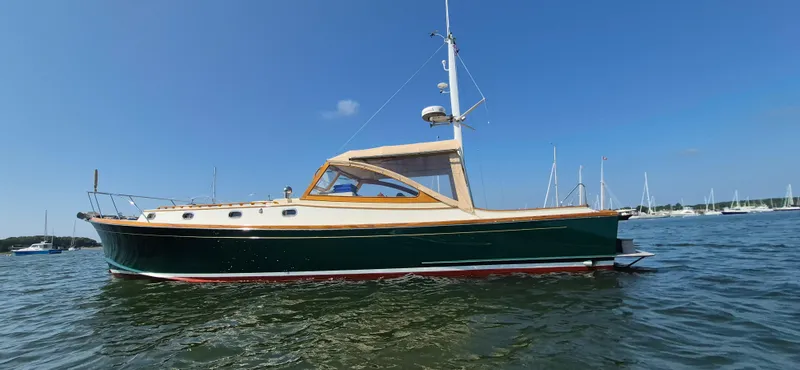 Slide: The Image of 1997 Able 44 Downeast Express Cruiser on calm water, clear sky background. - 1