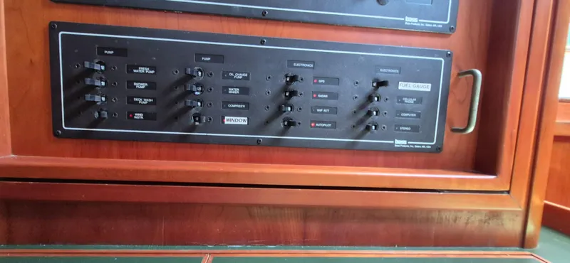 Slide: The Image of Control panel of a 1997 Able 44 Downeast Express Cruiser with various switches and labels. - 10