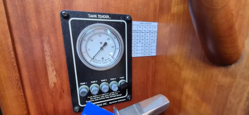 Slide: The Image of Tank tender gauge on 1997 Able 44 Downeast Express Cruiser, showing fuel and water levels. - 13