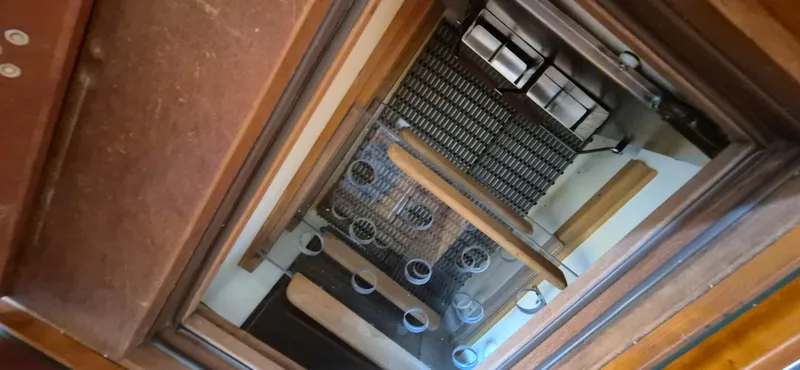 Slide: The Image of Interior view of 1997 Able 44 Downeast Express Cruiser, showcasing wooden and metal elements. - 16