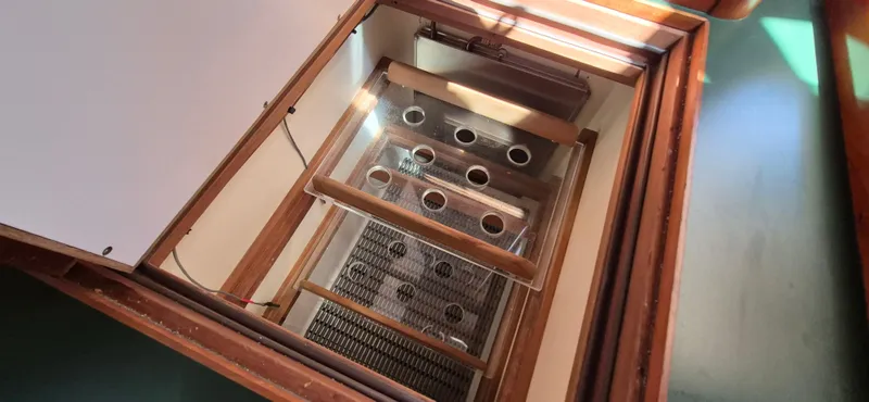 Slide: The Image of Engine compartment of 1997 Able 44 Downeast Express Cruiser, showcasing wooden and metal components. - 17