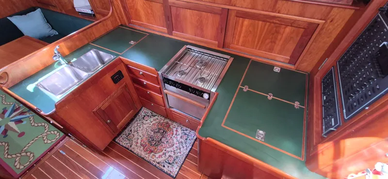 Slide: The Image of Luxurious 1997 Able 44 Downeast Express Cruiser kitchen with wood cabinetry and modern appliances. - 19