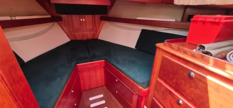 Slide: The Image of Cozy cabin interior of 1997 Able 44 Downeast Express Cruiser with wood finish and storage. - 26