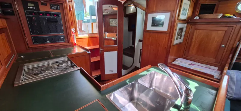 Slide: The Image of Interior of 1997 Able 44 Downeast Express Cruiser with wood cabinetry and stainless steel sink. - 29