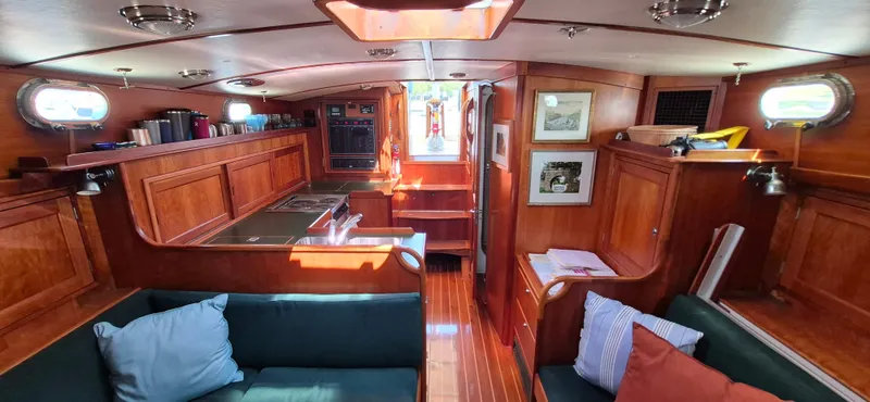 Slide: The Image of Interior of 1997 Able 44 Downeast Express Cruiser with wood paneling and cozy seating area. - 31