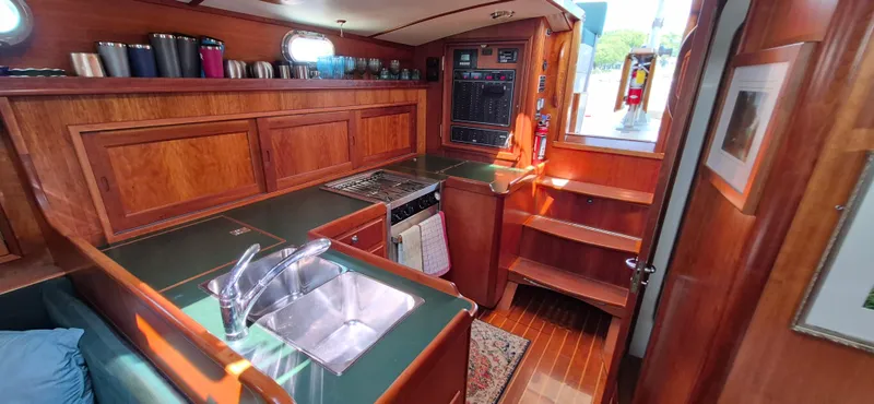 Slide: The Image of Interior of 1997 Able 44 Downeast Express Cruiser with wood cabinetry and kitchen amenities. - 32