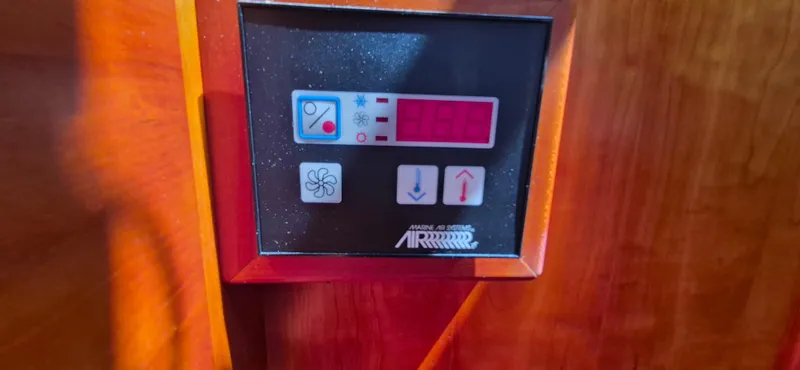 Slide: The Image of Control panel on 1997 Able 44 Downeast Express Cruiser, featuring temperature and fan settings. - 37