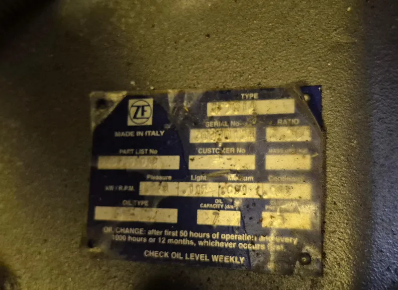 Slide: The Image of Label on machinery with specifications, including oil change instructions and ZF logo. - 46