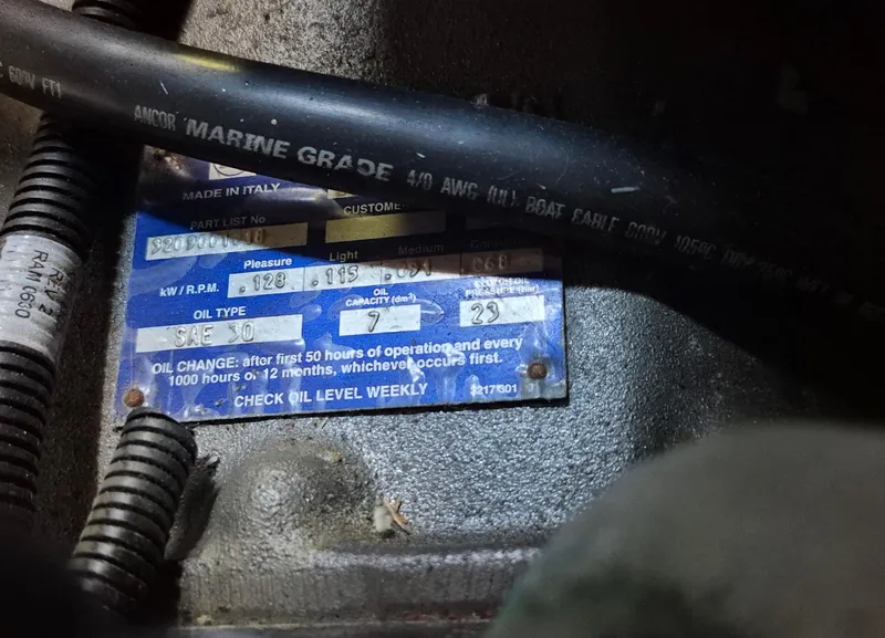 Slide: The Image of Engine label with oil change instructions on a 1997 Able 44 Downeast Express Cruiser. - 47