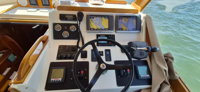 Slide: The Image of Helm of 1997 Able 44 Downeast Express Cruiser with navigation screens and controls. - 5