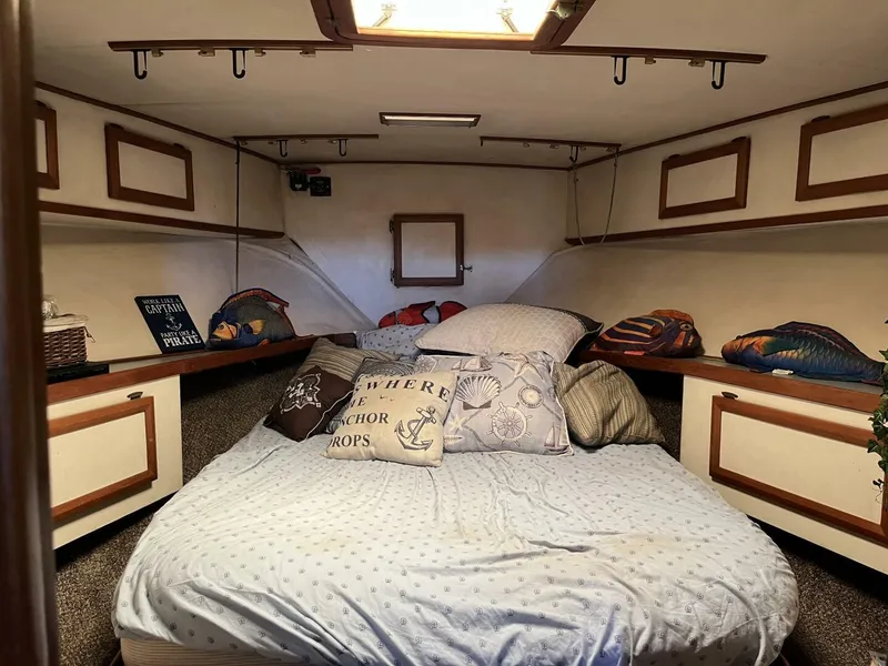 Slide: The Image of Cozy cabin interior of 1989 Topaz Sportfisherman with nautical-themed decor and comfortable bedding. - 17