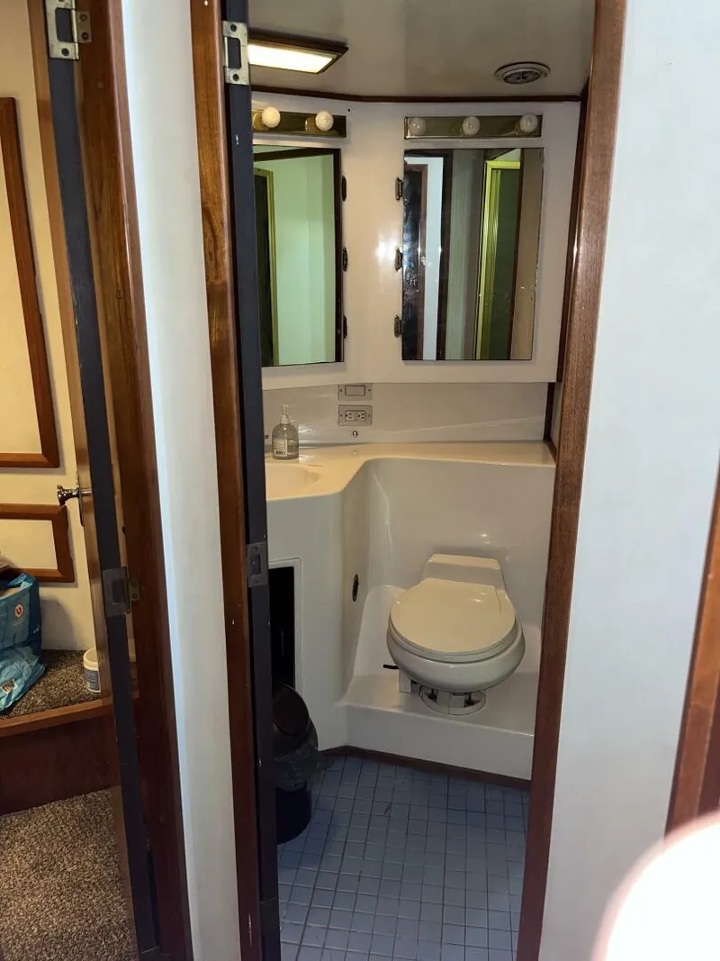 Slide: The Image of 1989 Topaz Sportfisherman bathroom with toilet, mirror, and compact design. - 18