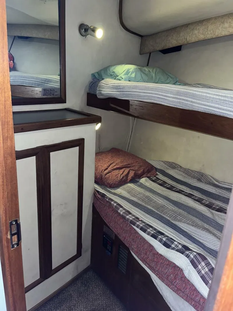 Slide: The Image of Cozy cabin interior of 1989 Topaz Sportfisherman with bunk beds and soft lighting. - 19