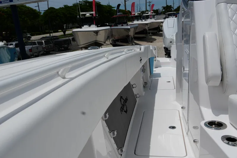 Slide: The Image of 2025 Fountain 38 CC boat interior with white seating and storage compartments. - 16