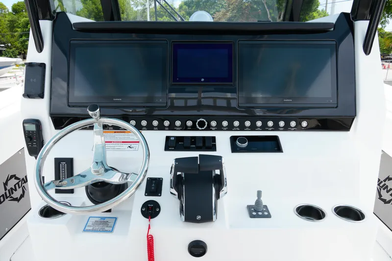 Slide: The Image of 2025 Fountain 38 CC boat dashboard with steering wheel and electronic displays. - 17