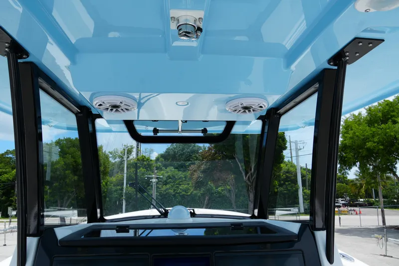 Slide: The Image of 2025 Fountain 38 CC boat interior with blue ceiling and speakers, showcasing modern design. - 18