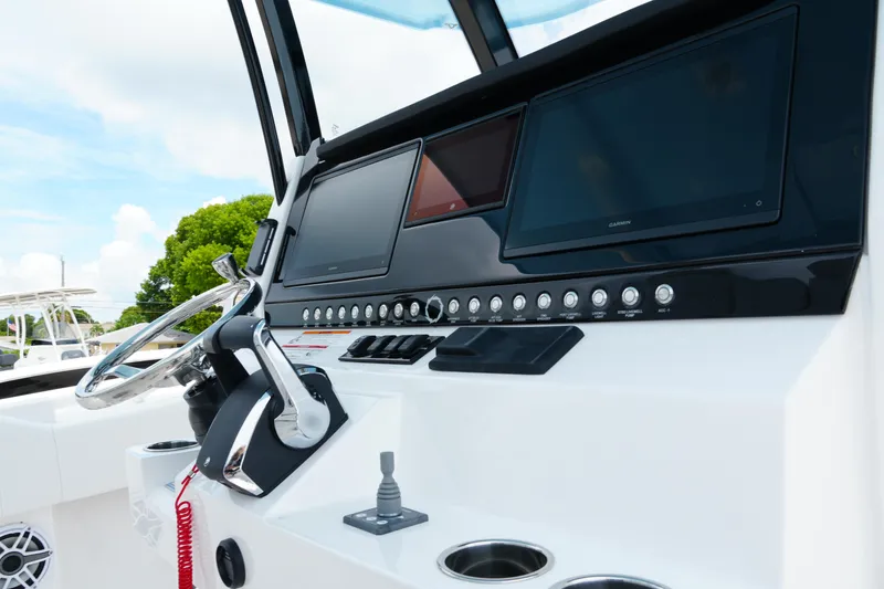 Slide: The Image of 2025 Fountain 38 CC boat dashboard with steering wheel and digital displays. - 21
