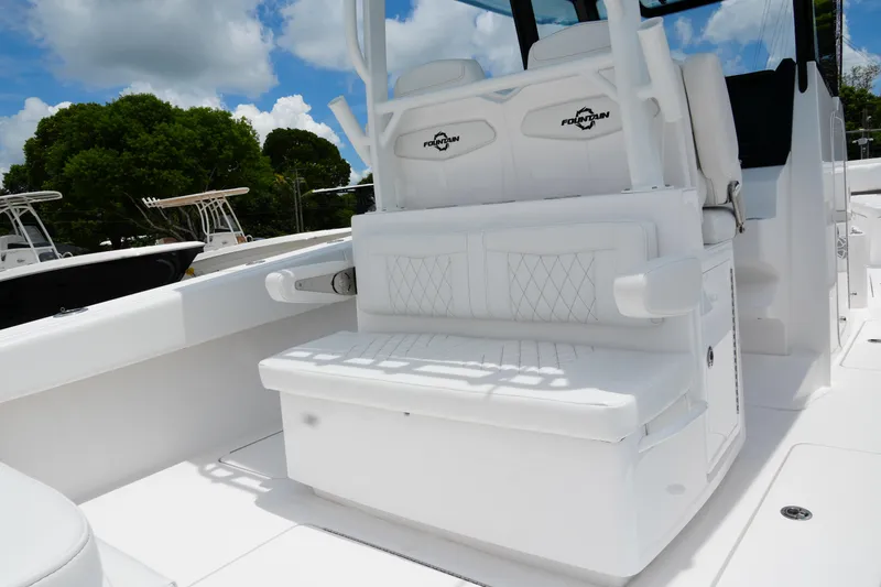 Slide: The Image of 2025 Fountain 38 CC boat interior with white seating and sleek design. - 28