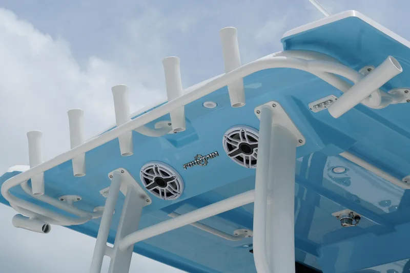 Slide: The Image of 2025 Fountain 38 CC boat with blue hull, rod holders, and speakers against a cloudy sky. - 8