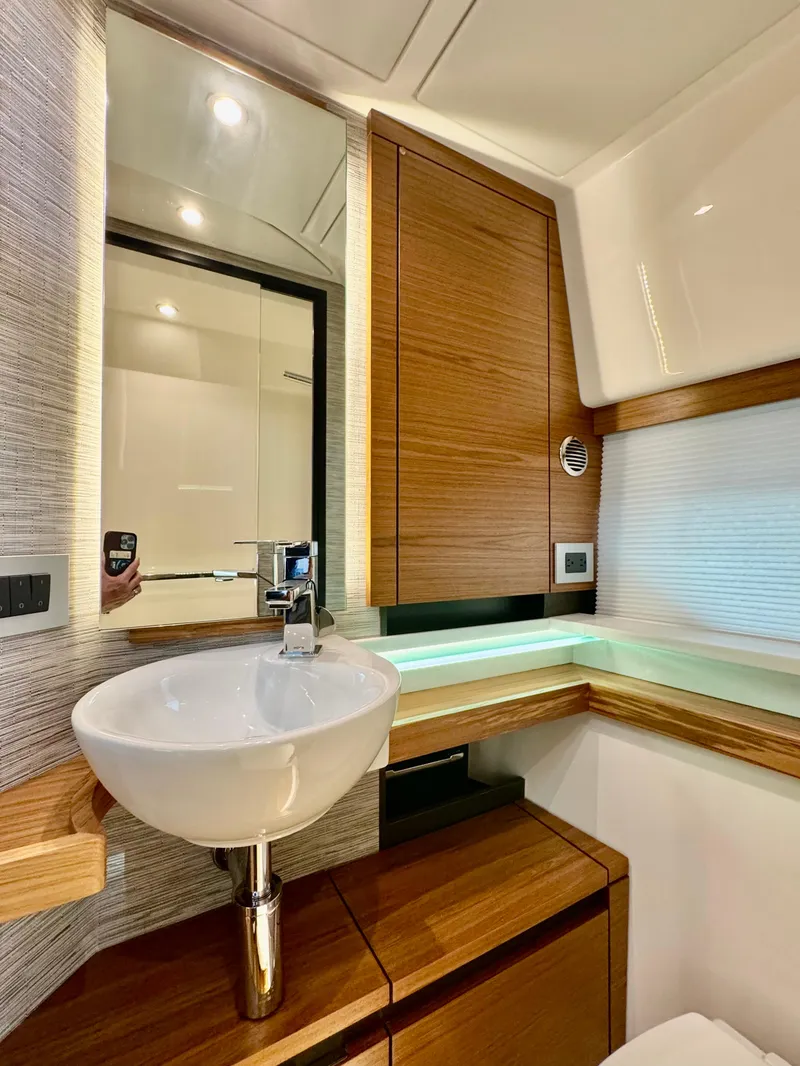 Slide: The Image of Luxurious bathroom interior of 2025 Tiara Yachts 43 LE, featuring modern sink and wood accents. - 33