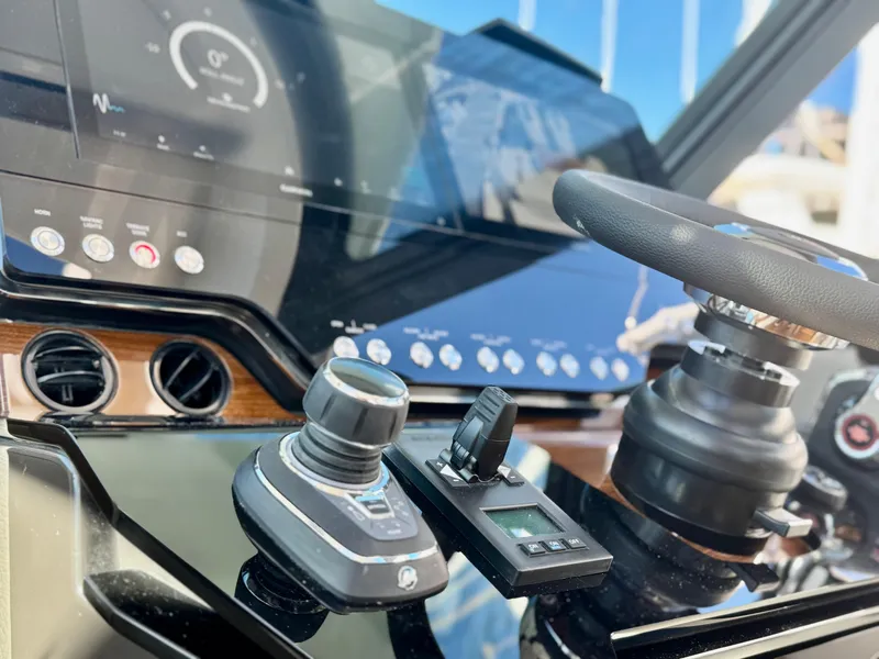Slide: The Image of 2025 Tiara Yachts 43 LE helm with advanced controls and navigation display. - 37