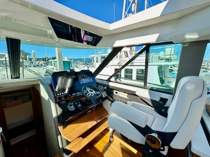 Slide: The Image of Helm of 2025 Tiara Yachts 43 LE with modern controls and panoramic windows. - 38