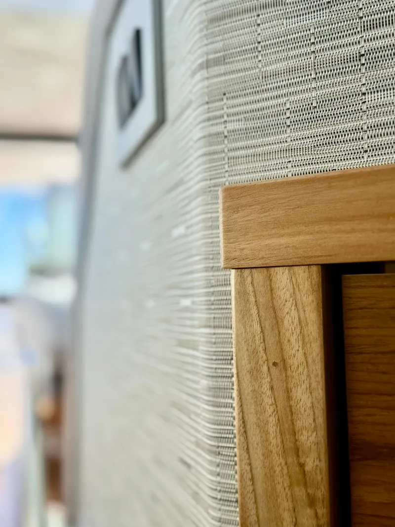 Slide: The Image of Close-up of 2025 Tiara Yachts 43 LE interior wood and fabric detail. - 42