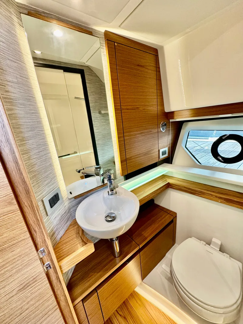 Slide: The Image of Luxurious bathroom in 2025 Tiara Yachts 43 LE, featuring modern fixtures and wood accents. - 44