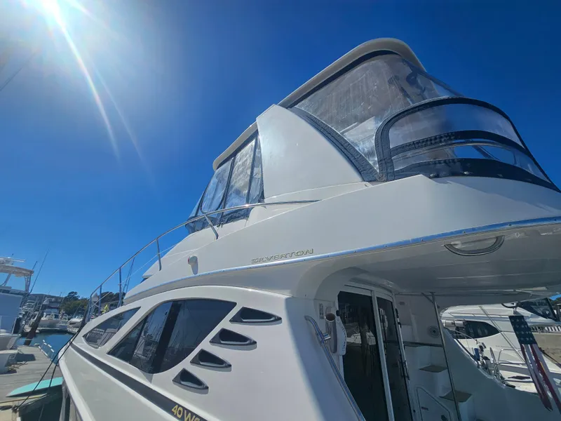 Slide: The Image of 2012 Silverton West Coast Edition yacht docked under clear blue sky. - 11
