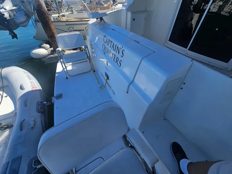 Slide: The Image of 2012 Silverton West Coast Edition boat deck with seating and inflatable dinghy. - 12