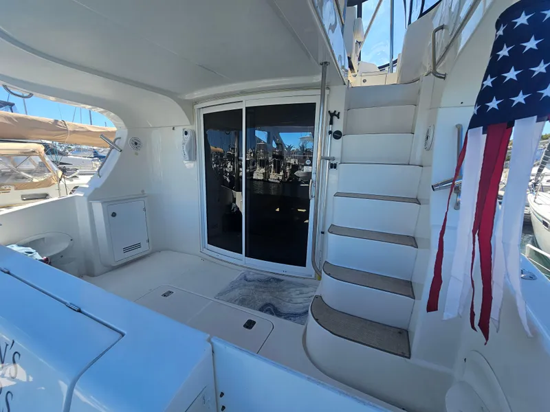 Slide: The Image of 2012 Silverton West Coast Edition yacht interior with stairs, sliding door, and American flag. - 15