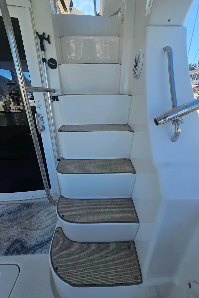 Slide: The Image of Staircase on 2012 Silverton West Coast Edition yacht, featuring sleek design and modern materials. - 16