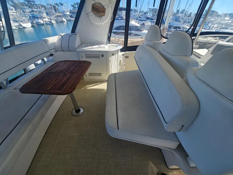 Slide: The Image of Luxurious 2012 Silverton West Coast Edition yacht interior with white seating and wooden table. - 18