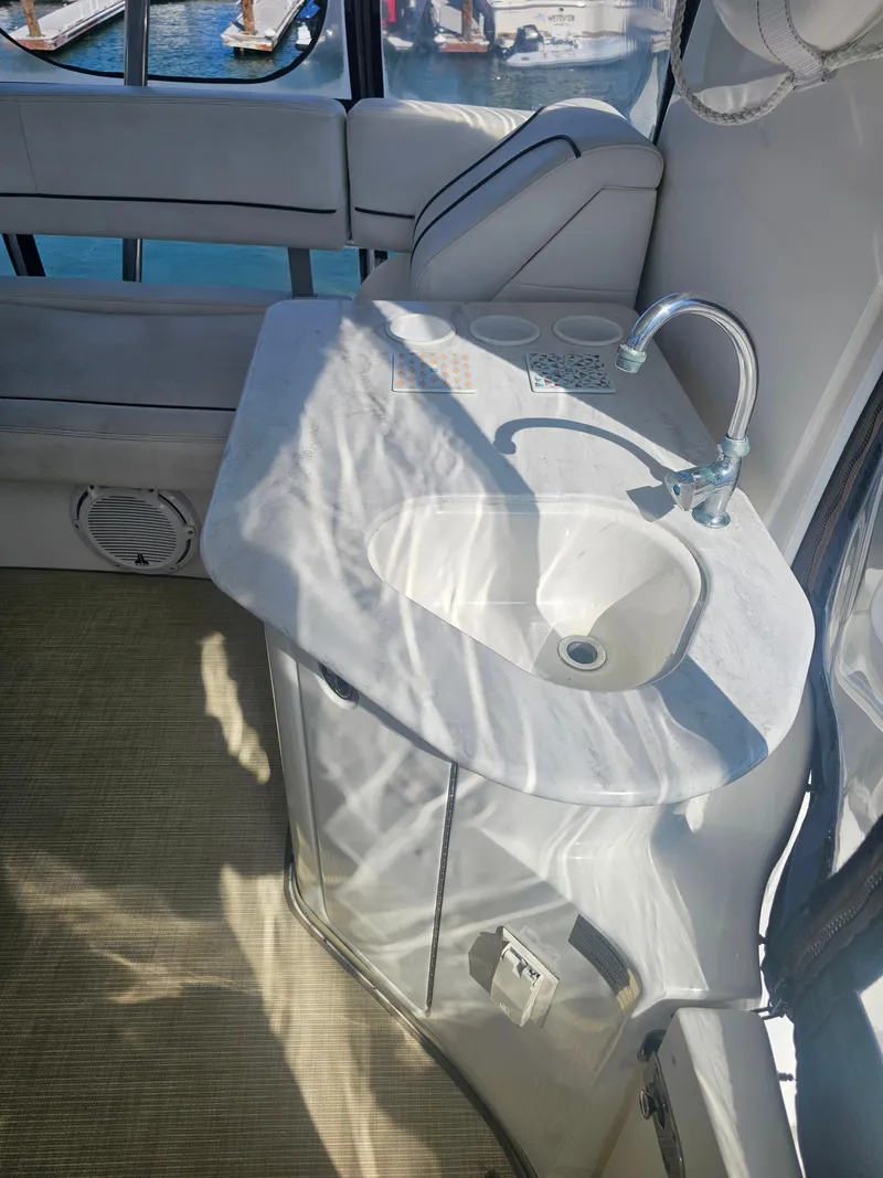 Slide: The Image of 2012 Silverton West Coast Edition yacht interior with sink and seating area. - 21