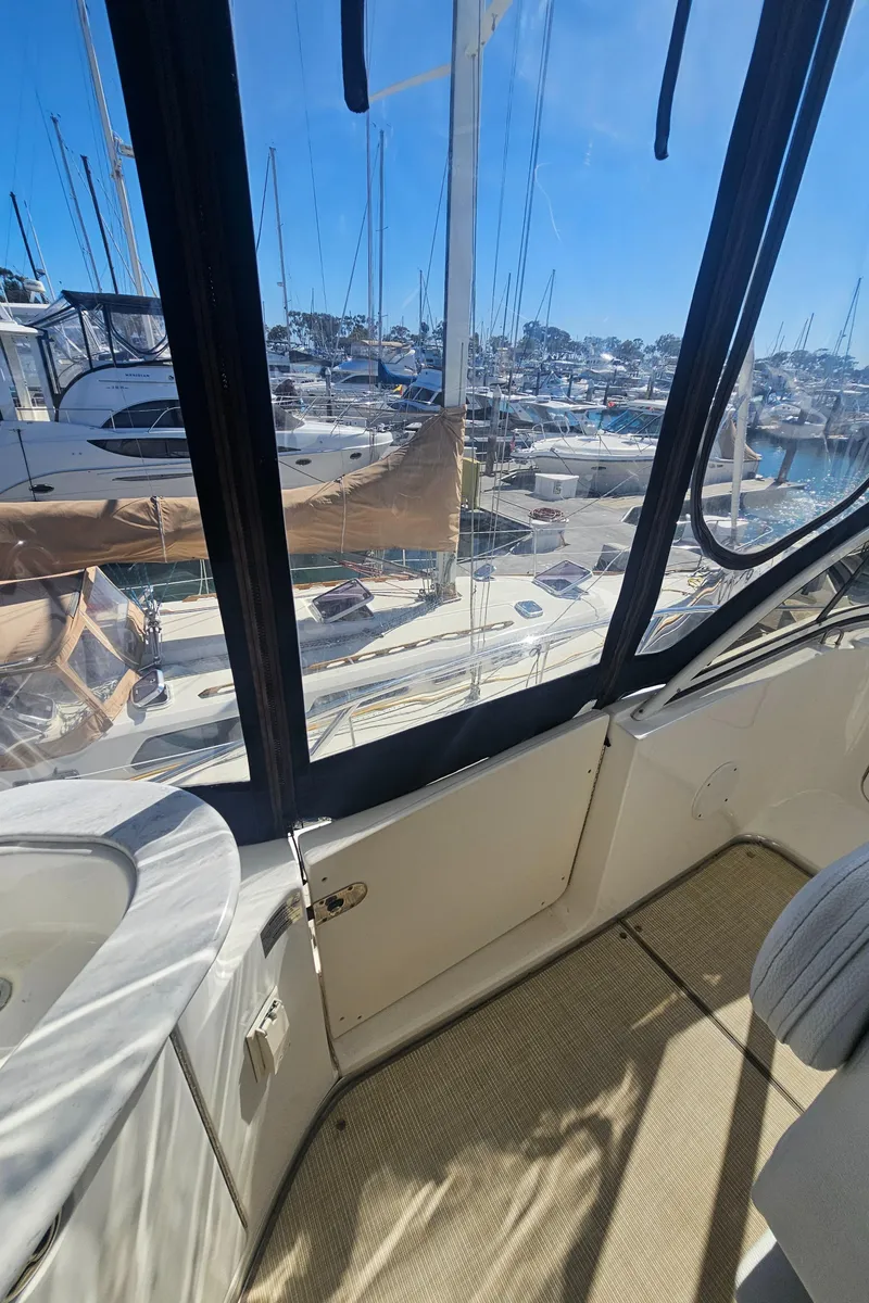 Slide: The Image of 2012 Silverton West Coast Edition yacht interior with marina view through windows. - 23